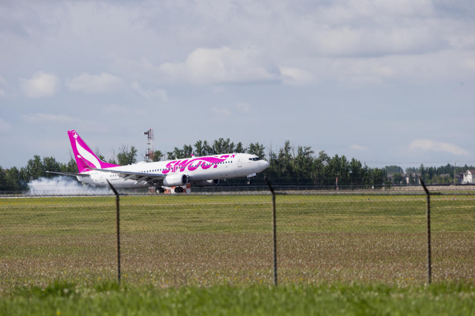 A Swoop Boeing 737-800 plane with identification C-FLSF landing at Edmonton International Airport. Swoop is operated by Westjet