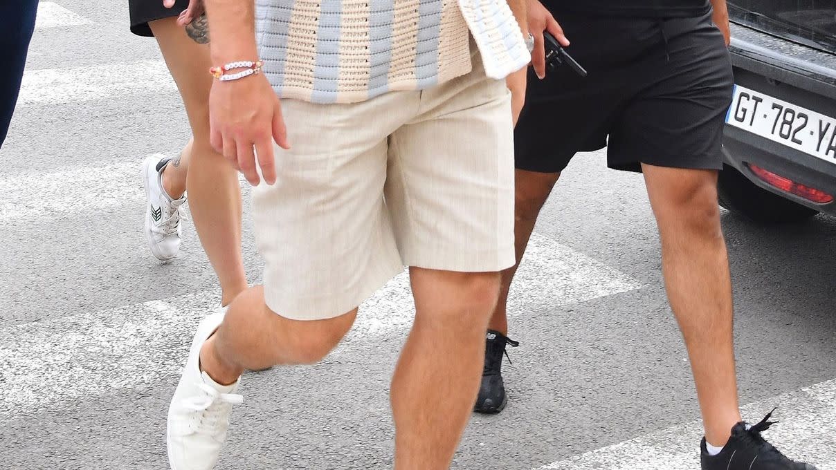 a man wearing a hat and shorts