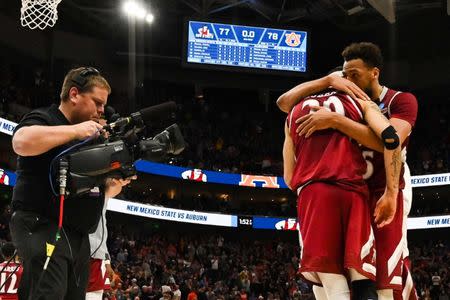 Mar 21, 2019; Salt Lake City, UT, USA; New Mexico State Aggies guard Trevelin Queen (20) and forward Johnny McCants (35) react to the loss to the Auburn Tigers in the first round of the 2019 NCAA Tournament at Vivint Smart Home Arena. Mandatory Credit: Kirby Lee-USA TODAY Sports