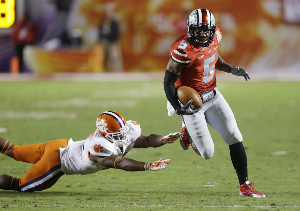 Ohio State quarterback Braxton Miller (5) runs past Clemson safety Robert Smith on his way to a touchdown during the first half of the Orange Bowl NCAA college football game, Friday, Jan. 3, 2014, in Miami Gardens, Fla. (AP Photo/Wilfredo Lee)