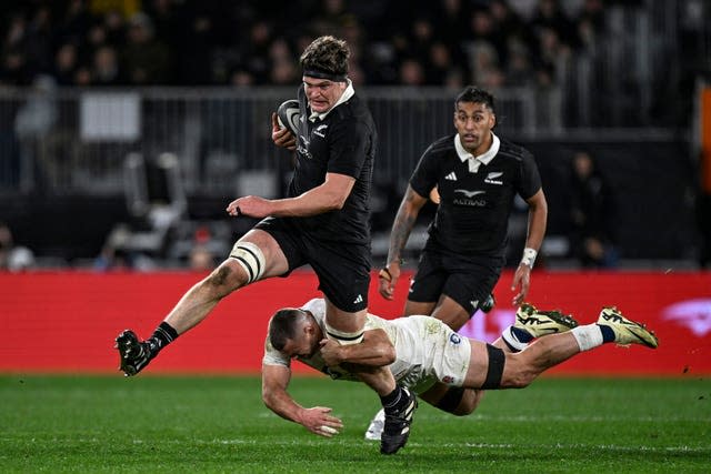 New Zealand's Scott Barrett is tackled by England's Ben Earl