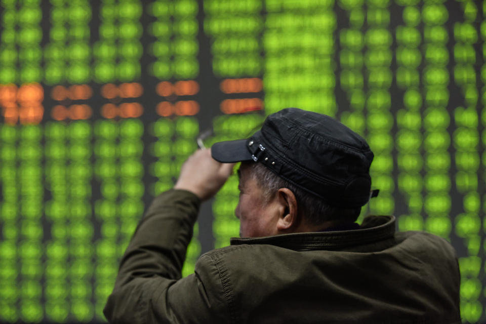 An investor looks at a screen showing stock market movements at a securities company in Hangzhou in China's eastern Zhejiang province on February 3, 2020. - Chinese stocks crashed on February 3 with some major shares quickly falling by the maximum daily limit as the country's investors got their first chance in more than a week to react to the spiralling coronavirus outbreak. (Photo by STR / AFP) / China OUT (Photo by STR/AFP via Getty Images)