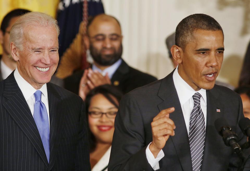 U.S. President Barack Obama (R) speaks about immigration reform next to U.S. Vice President Joe Biden in the East Room at the White House in Washington, October 24, 2013. REUTERS/Larry Downing (UNITED STATES - Tags: POLITICS SOCIETY IMMIGRATION)