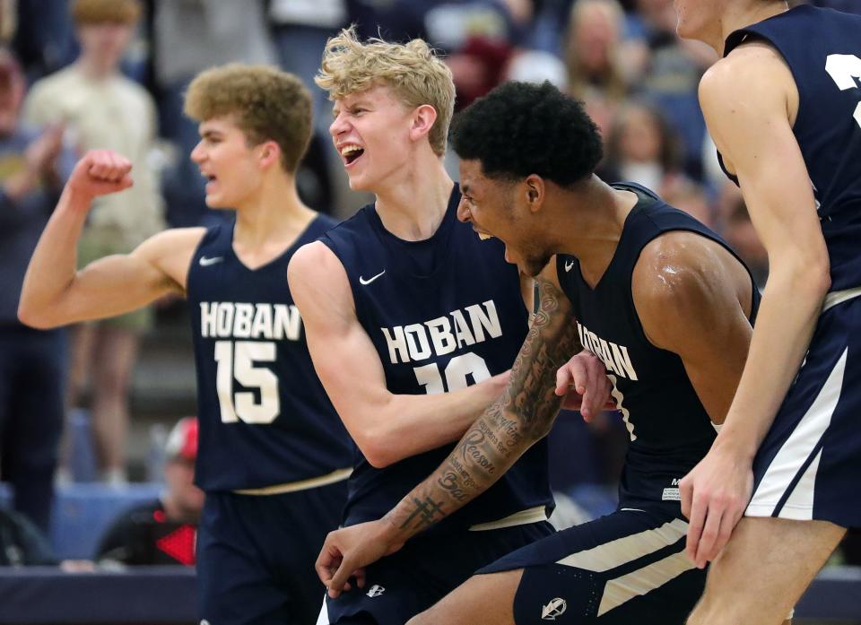 Archbishop Hoban guard Jonas Nichols, right, celebrates with Joey Hardman, center, and Logan Vowles, left, after beating Nordonia in a Division I district final at Twinsburg on March 4.
