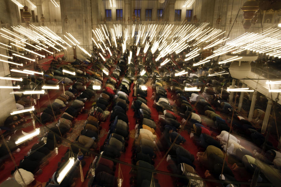 Muslims pray as they celebrate Eid al-Fitr, marking the end of the Muslim holy fasting month of Ramadan at Fatih mosque in Istanbul, Turkey, Friday, April 21, 2023. (AP Photo/Khalil Hamra)