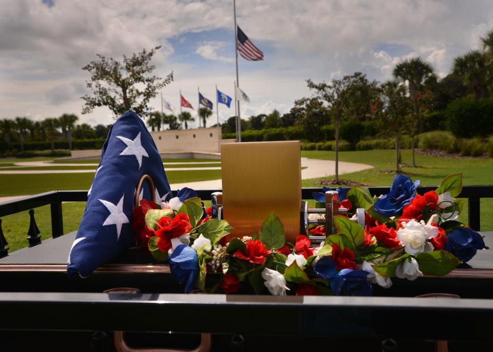 A mule-drawn caisson delivers U.S. Army Cpl. Leo J. Barlosky's remains alongside flowers and a folded U.S. flag during his interment ceremony at Cape Canaveral National Cemetery.