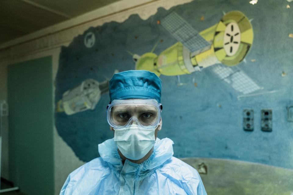 Ruslan Kushnir, medical worker, wearing a special suit to protect himself against coronavirus stands ready to meet a new patient with COVID-19 in a hospital organized in the medical college in Lviv, Western Ukraine, on Monday, Jan. 4, 2021. (AP Photo/Evgeniy Maloletka)