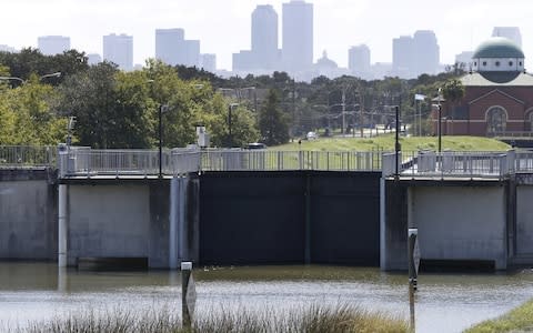 A pump station with the New Orleans skyline in the background - Credit: Reuters