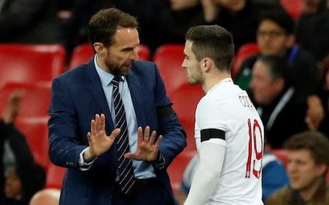 Gareth Southgate talks to Lewis Cook - Credit: Reuters