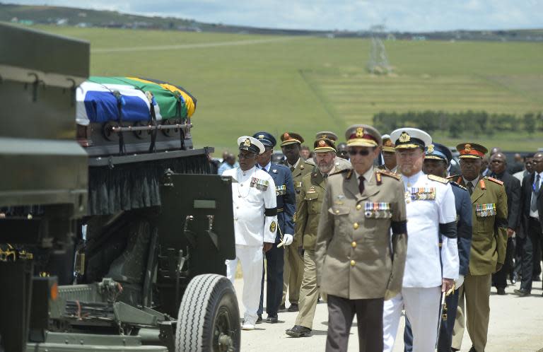 The coffin of South African former president Nelson Mandela is carried for a traditional burial during his funeral in Qunu on December 15, 2013