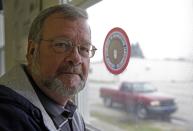 Bill Davis, of Gas City, Ind., poses in his union's meeting hall in Huntington, Ind., Tuesday, Dec. 6, 2016. Davis works at the United Technologies Electronic Controls factory in Huntington where workers are working mostly seven days a week since late October, making control panels for the furnace, air conditioning and refrigeration industries. Leaders of their union believe the company is doing so ahead of the factory's layoffs expected to start in April and continue into 2018. (AP Photo/Michael Conroy)