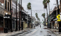 A man stands in the middle 7th Street in Ybor City on the rains soaked streets, a few hours before the high winds from Hurricane Ian hit Tampa, Fla., Wednesday, Sept. 28, 2022. (Willie J. Allen Jr./Orlando Sentinel via AP)