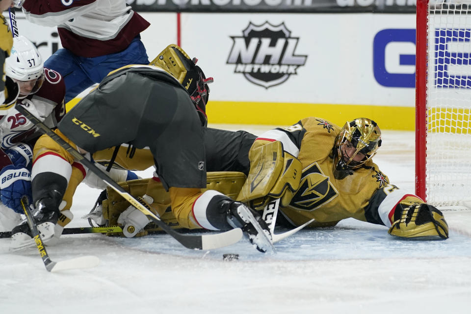 Vegas Golden Knights goaltender Marc-Andre Fleury (29) lies on the ice after blocking a shot by the Colorado Avalanche during the third period of an NHL hockey game Sunday, Feb. 14, 2021, in Las Vegas. (AP Photo/John Locher)