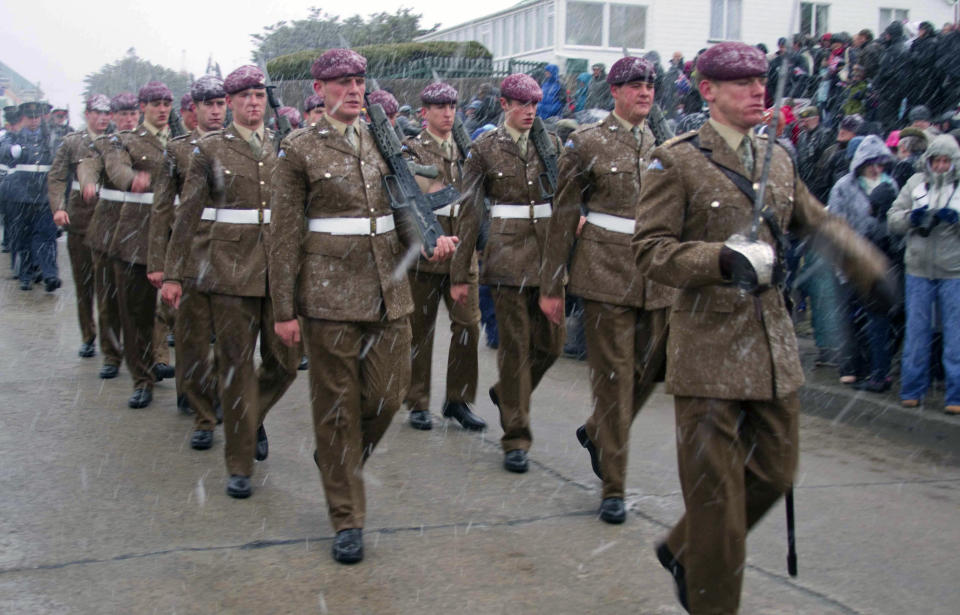 British soldiers parade in Port Stanley, Falkland Islands, Thursday, June 14, 2012, as Falkland Islanders commemorate Liberation Day paying homage to British soldiers who died in the 1982 war against Argentina. It snowed heavily as locals gathered to mark 30 years since the day British troops forced Argentina to give up its occupation. (AP Photo/Derek Pettersson)