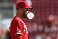 Cincinnati Reds' Eugenio Suarez blows a bubble while waiting for the next pitch against and Washington Nationals during the ninth inning of a baseball game Sunday, Sept. 26, 2021, in Cincinnati. The Reds defeated the Nationals 9-2. (AP Photo/Jay LaPrete)