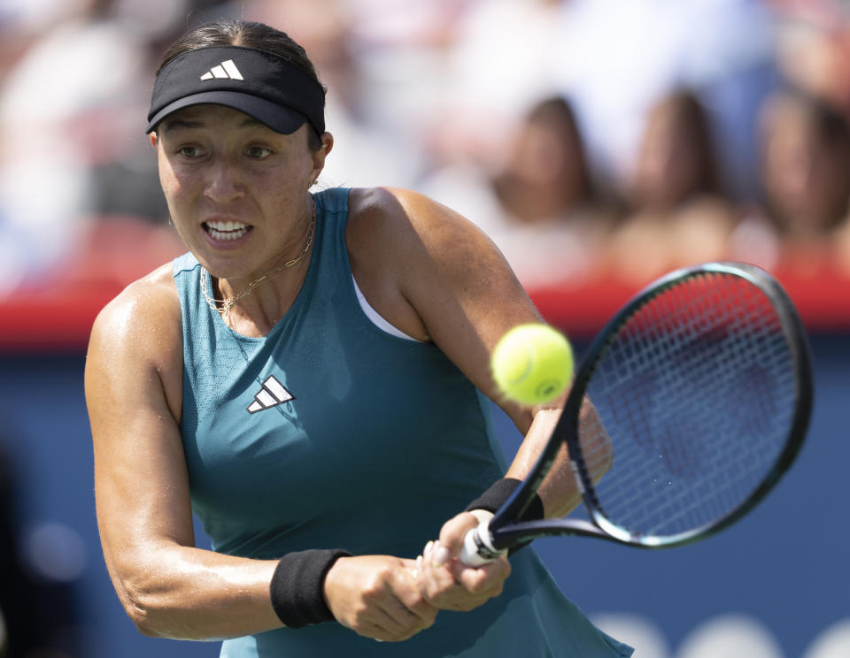 Jessica Pegula of the United States, hits a return to Iga Swiatek of Poland, during the semifinals of the National Bank Open women’s tennis tournament Saturday, Aug. 12, 2023, in Montreal. (Christinne Muschi/The Canadian Press via AP)