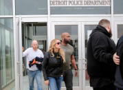 Adult film star Stormy Daniels, whose real name is Stephanie Clifford, and her security leave the Detroit Police Department 4th Precinct after picking up her temporary Dance Permit license to perform at a club in Detroit, Michigan, U.S., April 18, 2018. REUTERS/Rebecca Cook