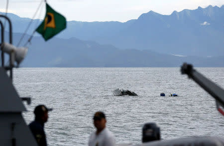 Rescue workers are seen near a plane, which crashed with Brazilian Supreme Court Justice Teori Zavascki, who was overseeing a graft investigation into scores of powerful politicians, in Paraty, Rio de Janeiro state, Brazil, January 20, 2017. REUTERS/Bruno Kelly