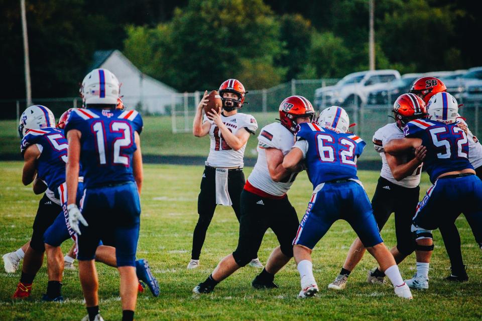 Southern Boone quarterback Austin Evans (18) catches the snap for a play. Evans threw four touchdowns in the Eagles' 29-28 win over California on Sept. 9, 2022.