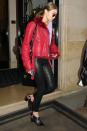 <p>In a red fur-lined leather jacket, purple tee, black leather skinny jeans by J Brand, heeled mules, a black leather backpack and rounded sunglasses while out in Paris.</p>