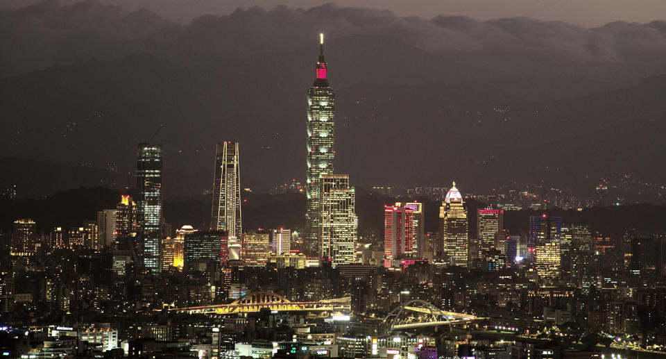 Fifty-six Chinese warplanes crossed into Taiwan's defence zone on Monday. A stock photo of Taipei's skyline at night is pictured.