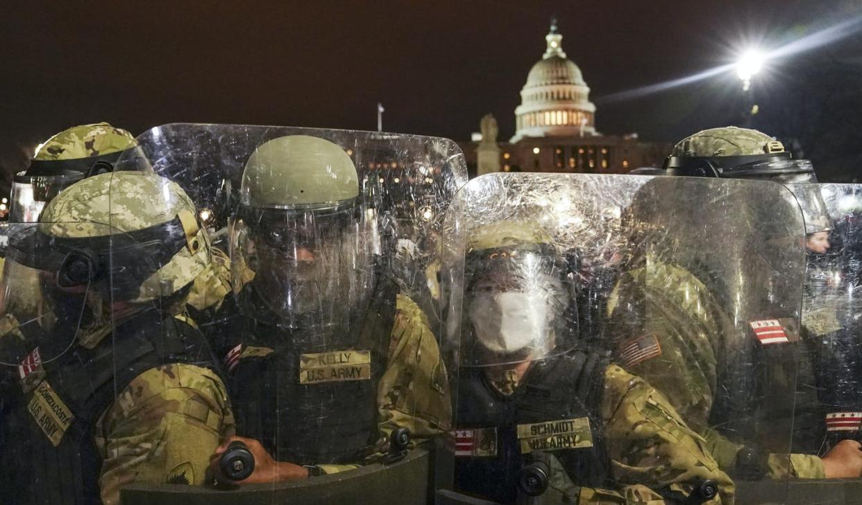 <span class="caption">DC National Guard stand outside the Capitol on Jan. 6, 2021, after Trump supporters stormed the building in an attempt to overturn the U.S. presidential election.</span> <span class="attribution"><span class="source">(AP Photo/John Minchillo)</span></span>