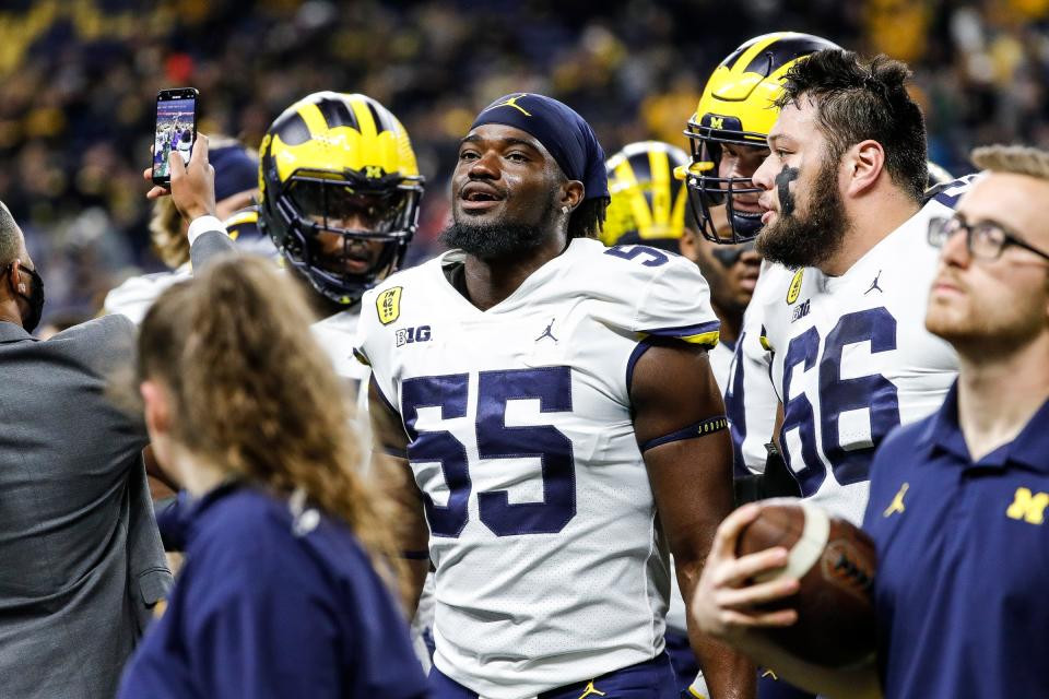 Michigan linebacker David Ojabo, center, during warmups before the Big Ten championship game against Iowa on Saturday, Dec. 4, 2021, at Lucas Oil Stadium in Indianapolis.