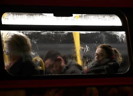 A woman dozes a packed bus during a strike on the Underground by members of two unions in protest at ticket office closures and reduced staffing levels, in London, Britain January 9, 2017. REUTERS/Dylan Martinez