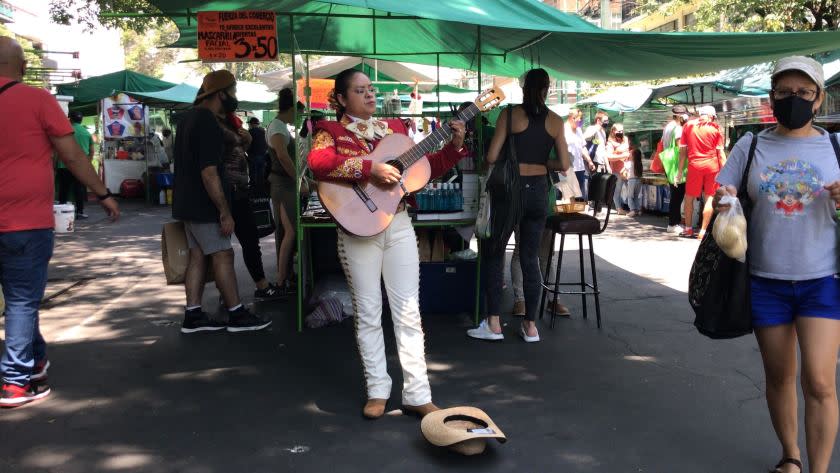 Mariachi singer Nancy Velasco, who has performed on some of Mexico's biggest stages, has been singing for tips at Mexico City markets since the COVID-19 pandemic hit. <span class="copyright">(Kate Linthicum / Los Angeles Times)</span>