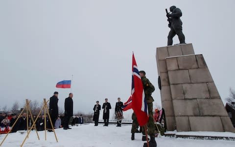 Norway and Russia's foreign ministers pay their respects on Friday at a memorial to the Soviet soldiers who liberated Kirkenes from the Nazis - Credit: Maxim Shemetov/Reuters