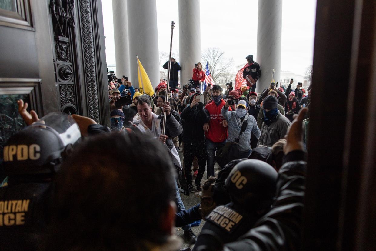 WASHINGTON D.C., USA - JANUARY 6: Police intervenes in US President Donald Trumps supporters who breached security and attempt to enter the Capitol building in Washington D.C., United States on January 06, 2021. Pro-Trump rioters stormed the US Capitol as lawmakers were set to sign off Wednesday on President-elect Joe Biden's electoral victory in what was supposed to be a routine process headed to Inauguration Day. (Photo by Mostafa Bassim/Anadolu Agency via Getty Images)