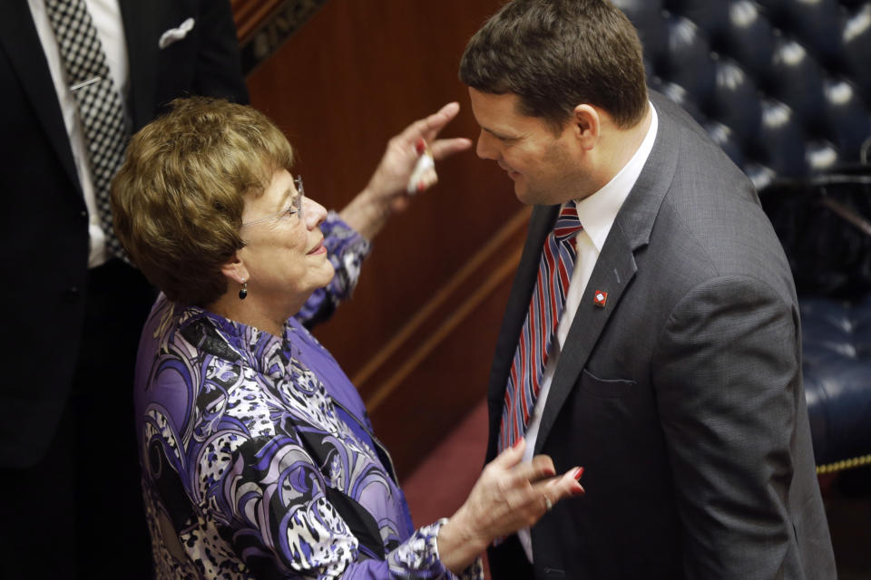 Sen. Jane English, R-North Little Rock, left, speaks with Sen. Bart Hester, R-Cave Springs, in the Senate chamber at the Arkansas state Capitol in Little Rock, Ark., Thursday, Feb. 20, 2014. The Senate voted Thursday to continue the state's compromise Medicaid expansion plan. (AP Photo/Danny Johnston)