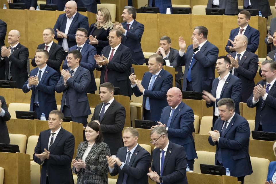 Russian lawmakers applaud after voting for Russian constitutional amendments during a session at the Russian State Duma, the Lower House of the Russian Parliament in Moscow, Russia, Thursday, Jan. 23, 2020. Kremlin-controlled lower house of parliament, the State Duma, unanimously voted for constitutional amendments on Thursday, widely seen as President Vladimir Putin's strategy to stay in power well past the end of his term in 2024. (AP Photo/Alexander Zemlianichenko)