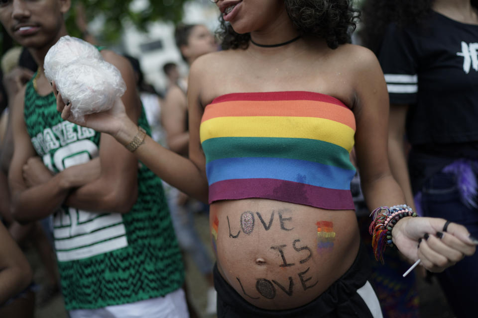 A pregnant woman attends the annual gay pride parade along Copacabana beach in Rio de Janeiro, Brazil, Sunday, Sept. 22, 2019. The 24th gay pride parade titled this year's parade: "For democracy, freedom and rights, yesterday, today and forever." (AP Photo/Leo Correa)