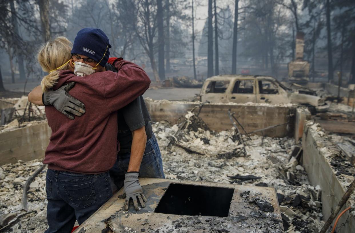 The 2018 Camp Fire killed 85 people and destroyed 20,000 buildings in and around Paradise, Calif. <a href="https://www.gettyimages.com/detail/news-photo/michael-john-ramirez-hugs-his-wife-charlie-ramirez-after-news-photo/1062031052" rel="nofollow noopener" target="_blank" data-ylk="slk:Marcus Yam /Los Angeles Times via Getty Images;elm:context_link;itc:0;sec:content-canvas" class="link ">Marcus Yam /Los Angeles Times via Getty Images</a>