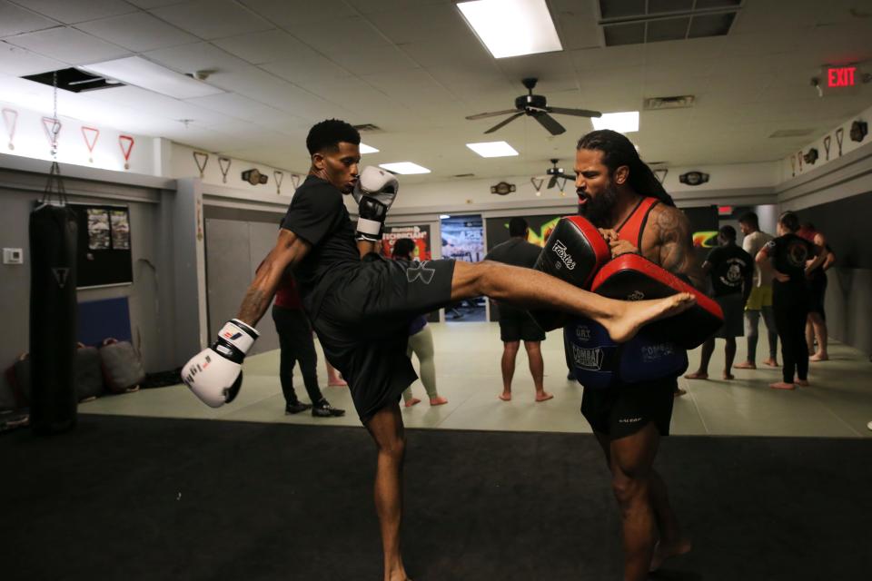 Savannah native and resident Eddie Lomonte, left, fires off a powerful kick while practicing with trainer Muhsin Corbbrey at Champions Training Center on Thursday, July 21, 2022.