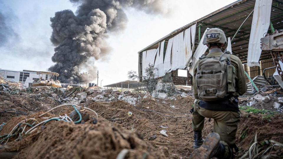 PHOTO: An Israeli soldier takes a position soldier as smoke billows in the Gaza Strip, Dec. 19, 2023. (Israeli Defense Forces/AFP via Getty Image)