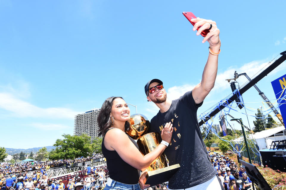 OAKLAND, CA - JUNE 15: Ayesha Curry and Stephen Curry #30 of the Golden State Warriors pose for a 'selfie' with the Larry O'Brien Trophy during the Victory Parade and Rally on June 15, 2017 in Oakland, California at The Henry J. Kaiser Convention.&nbsp;