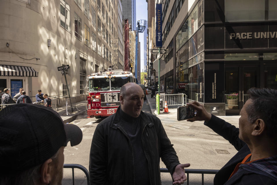 Adam Cohen speaks with the member of the press after his car was trapped in a partially collapsed parking garage in the Financial District of New York, Wednesday, April 19, 2023, in New York. The parking garage collapsed Tuesday, killing one worker, injuring five and crushing cars as concrete floors fell on top of each other like a stack of pancakes, officials said. (AP Photo/Yuki Iwamura)