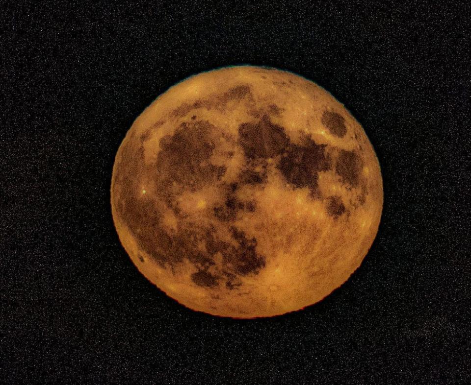 The full Sturgeon supermoon, photographed over the Hudson River in New York,  Aug. 1, 2023. The lack of light pollution allowed for the appearance of distant stars.