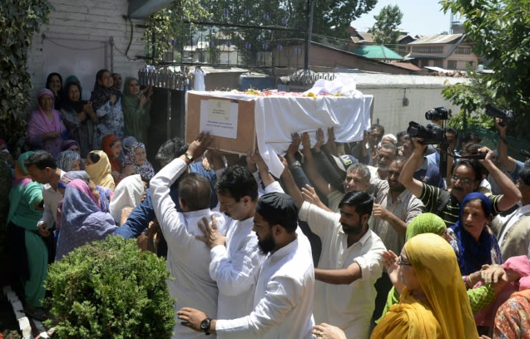 Relatives of police officer Mohammad Ayub Pandith who was beaten to death by a mob carry his coffin in Srinagar