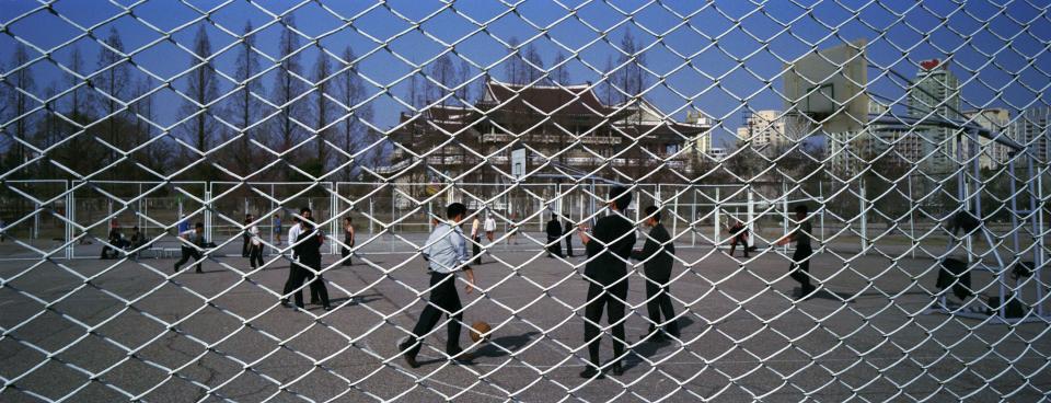 In this April 17, 2012 photo, North Koreans play basketball at a public court in Pyongyang, North Korea. Flamboyant former NBA star Dennis Rodman is heading to North Korea with VICE media company - tattoos, piercings, bad-boy reputation and all. The American known as "The Worm" is set to arrive Tuesday, Feb. 26, 2013 in Pyongyang, becoming an unlikely ambassador for sports diplomacy at a time of heightened tensions between the U.S. and North Korea. (AP Photo/David Guttenfelder)