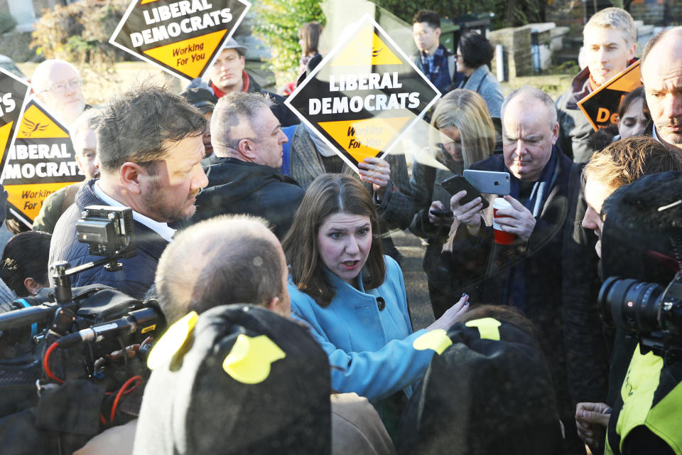 Liberal Democrat Leader Jo Swinson speaks to Extinction Rebellion protesters dressed as bees after they glued themselves to the party's battle bus during a visit to Knights Youth Centre in London, while on the General Election campaign trail.
