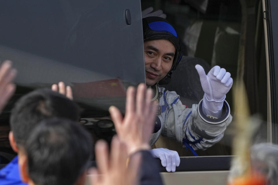 Chinese astronaut for the Shenzhou-18 mission Ye Guangfu gestures from a vehicle during a send-off ceremony for their manned space mission at the Jiuquan Satellite Launch Center in northwestern China, Thursday, April 25, 2024. (AP Photo/Andy Wong)