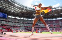 <p>Malaika Mihambo of Team Germany jumps with her country's flag after winning the gold medal in the Women's Long Jump Final at Olympic Stadium on August 3.</p>