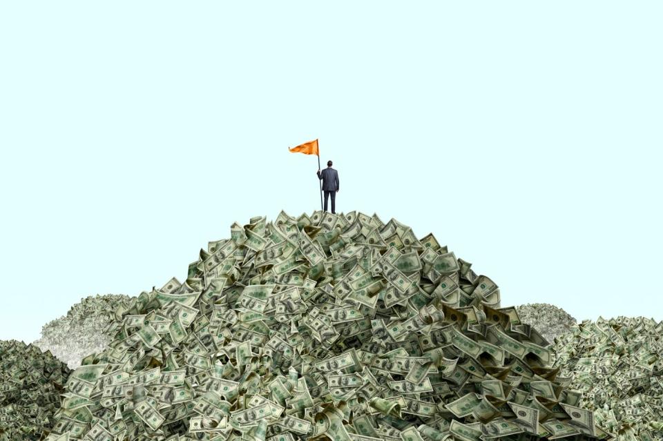 A person standing on a pile of money