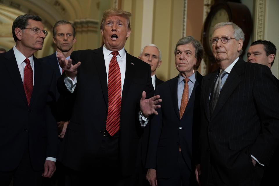 President Donald Trump speaks to members of the media as (L-R) Sen. John Barrasso (R-WY), Sen. John Thune (R-SD), Vice President Mike Pence, Sen. Roy Blunt (R-MO), Senate Majority Leader Sen. Mitch McConnell (R-KY) and Sen. Todd Young (R-IN) listen at the U.S. Capitol.