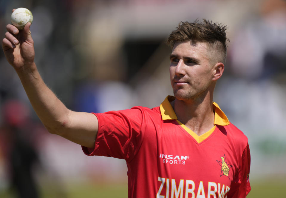 Zimbabwean bowler Bradley Evans holds the ball after taking 5 wickets on the last day of the One-Day International cricket match between Zimbabwe and India at Harare Sports Club in Harare, Zimbabwe, Monday, Aug, 22, 2022. (AP Photo/Tsvangirayi Mukwazhi)