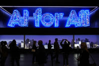 People walk by the Samsung booth during the CES tech show Tuesday, Jan. 9, 2024, in Las Vegas. (AP Photo/John Locher)