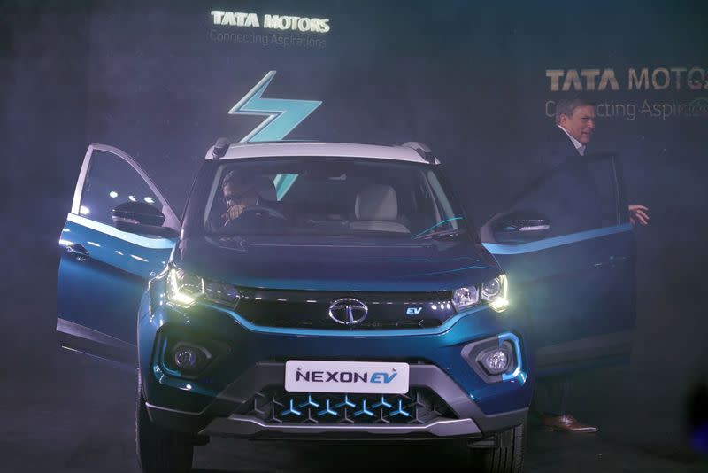 FILE PHOTO: Natarajan Chandrasekaran, Chairman of Tata Sons, sits inside the company's electric sport-utility vehicle (SUV) Nexon EV next to Guenter Butschek, CEO and Managing Director at Tata Motors, during the launch of the vehicle in Mumbai